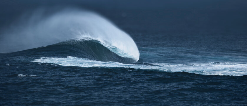 Powerful Ocean Wave Breaking in Stormy Sea with Dramatic Sea Spray