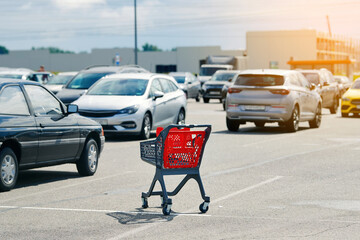Abandoned shopping cart hazard including collision risk and property damage. Dangers of abandoned shopping cart left in parking lot traffic zone with cars, trucks and other vehicles driving nearby © Tricky Shark