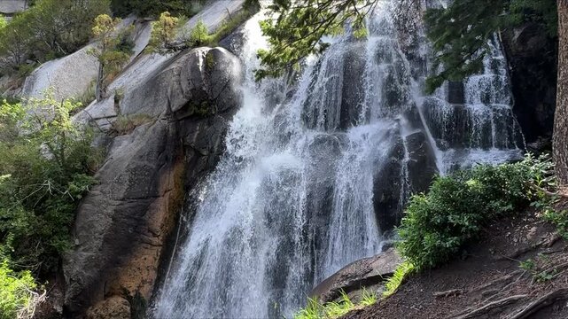 Waterfall in Utah&rsquo;s Wasatch Mountains, with water cascading over rocky cliffs and surrounded by lush forest.
