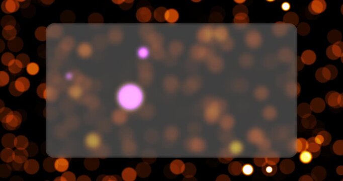 Warm glowing bokeh lights hover near a clear glass plate in a seamless loop sequence. Soft particle illumination produces a warm and captivating background texture.
