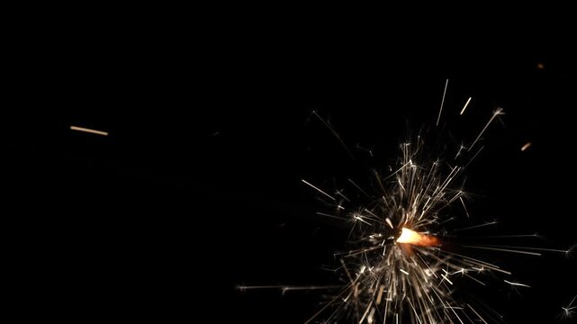 Close-up of Golden Sparkler Emitting Sparks on a Black Background in 4K