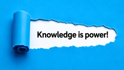 Fototapeta premium Torn paper reveal with the message knowledge is power on a blue background