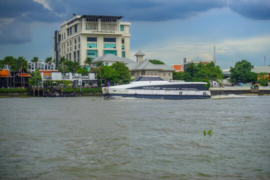 Bangkok, Thailand - June  16, 2026 : Electric passenger boats operating on the Chao Phraya River during the daytime.