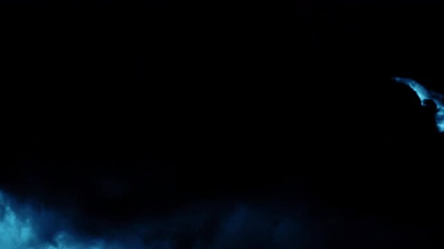 Dramatic dark storm clouds with intense lightning flashes at night