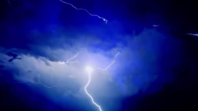 Lightning strike in dark stormy clouds at night