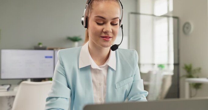 Operator with headset woman delivering customer support. She works on a laptop in an office, answering a call and resolving issues. Perfect for customer service, tutorials and remote help
