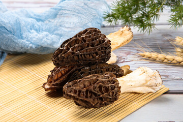 Fresh Morel Mushrooms In Woven Bamboo Basket With Wolfberry © ads