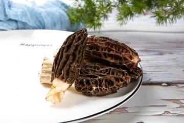 Fresh Morel Mushrooms In Woven Bamboo Basket With Wolfberry © ads