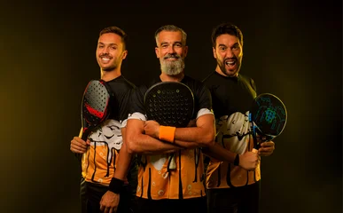 Team of padel tennis player with racket. Men athletes with paddle racket on court with neon colors. Sport concept. Download a high quality photo for the design of a sports app or betting site. © Mike Orlov