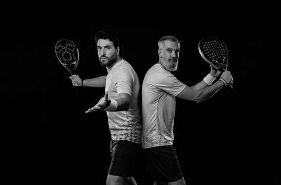 Padel tennis doubles. Two athletes players with racket. Man athlete with paddle racket on court with neon colors. Sport concept. Download a high quality photo for the design of a sports app