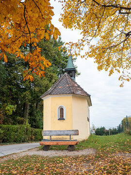 Chapel and bench in fall with colorful foliage