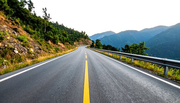 An asphalt road curves through a lush green hillside and distant mountains under a bright sky. The road's center line is vibrant yellow