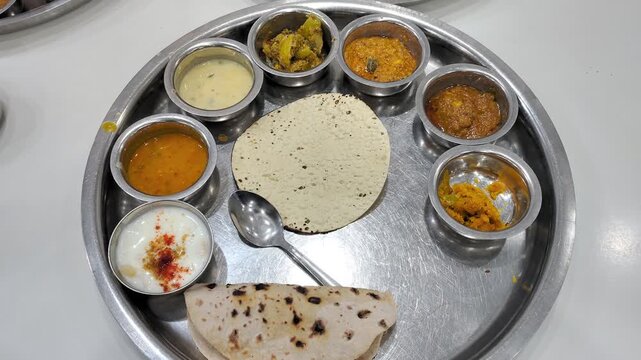 Authentic Indian Thali Meal Served in Traditional Metal Plate and Bowls