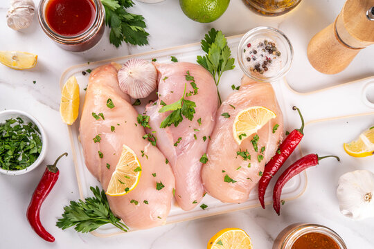 Fresh raw organic chicken breast fillet, with spices and condiments