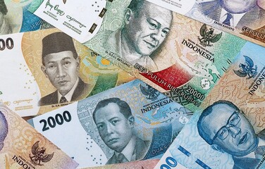 Indonesian rupiah money banknotes pile on table. Indonesia bills of IDR currency close up © Larysa