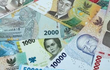 Indonesian rupiah money banknotes pile on table. Indonesia bills of IDR currency close up © Larysa