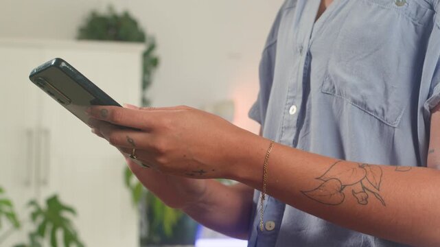 Close-Up Of A Person's Hands Using A Smartphone For Browsing Digital Content Online