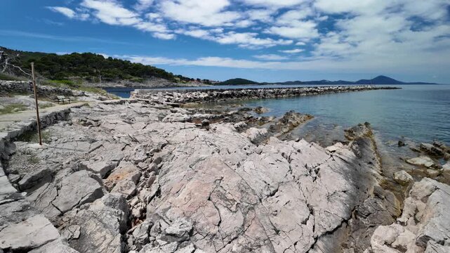 Picturesque harbor of Luka Rovenska on Losinj Island, Croatia. Traditional fishing village with colorful waterfront and crystal clear Adriatic Sea on a sunny summer day in Losinj Island of Croatia