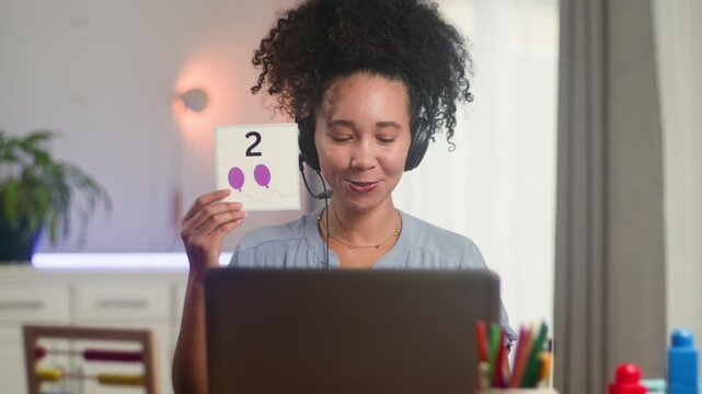 Engaging Online Math Lesson: Young Black Woman Teaches Counting Remotely for Primary School