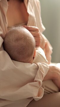 Nurturing mother breastfeeding her newborn baby, a close up showcasing the intimate bond, infant care, motherhood love, and the tender moments of parenting in a calm home environment
