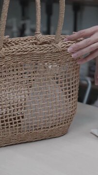 Close up of hands tying a string on a reusable cotton drawstring bag, handmade reusable cotton bags.