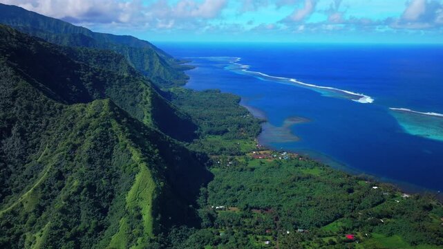 Aerial view coastline End of the Road town of Teahupo'o village Tahiti French Polynesia drone Teahupo'o wave lagoon surfing Passe Havea deep blue South Pacific Ocean coral reef forward pan up