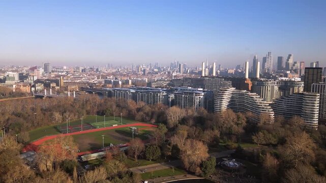 Aerial drone view of Battersea athletics track featuring Londons skyscrapers 