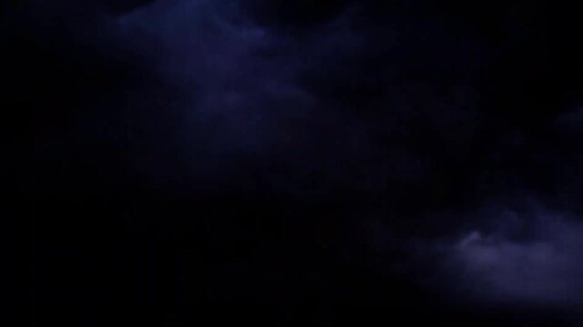 Bright lightning bolt striking through a dark stormy night sky
