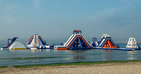 Colorful Inflatable floating water park with slides anchored in sea near beach © isabela66