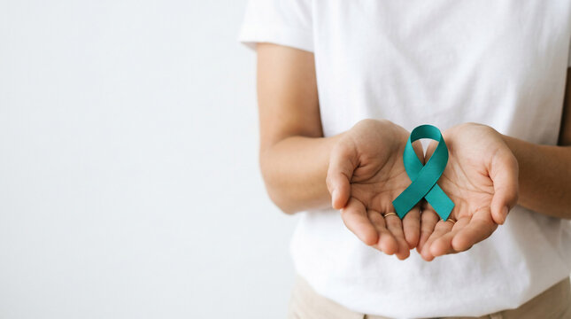 Woman holding a teal ribbon in cupped hands, close-up shot, suitable for health awareness campaigns, charity events and medical support programs