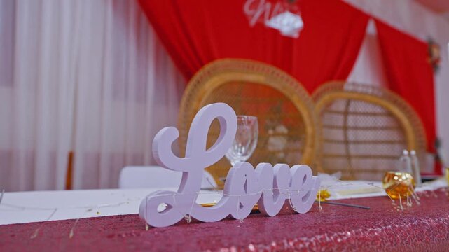 Romantic Love Sign on Elegant Wedding Reception Table