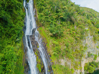 Aerial drone view of greenery hills with Situmurun Waterfall near Toba Lake at Lumban Juju in Toba, Sumatera Utara, Indonesia © MUAZ JAFFAR