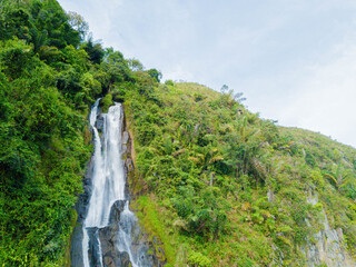 Aerial drone view of greenery hills with Situmurun Waterfall near Toba Lake at Lumban Juju in Toba, Sumatera Utara, Indonesia © MUAZ JAFFAR