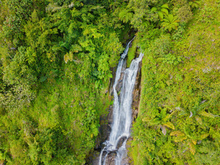 Aerial drone view of greenery hills with Situmurun Waterfall near Toba Lake at Lumban Juju in Toba, Sumatera Utara, Indonesia © MUAZ JAFFAR