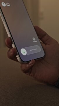Person Receiving and Answering an Incoming Call on a Smartphone.