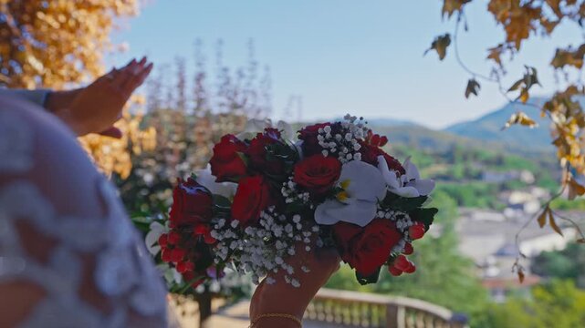 Bride Holding Wedding Bouquet with Scenic Mountain Landscape Background