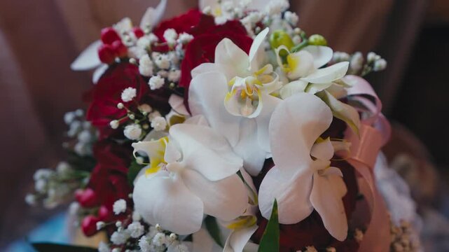 Elegant Wedding Bouquet with White Orchids and Red Roses Close Up