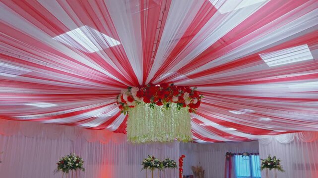 Elegant Wedding Reception Ceiling Decor with Red and White Drapes