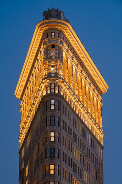 New York City, NY, USA - July 1st, 2026: Flatiron Building at dusk with newly illuminated facade. Flatiron District (Broadway and Fifth Avenue), Manhattan