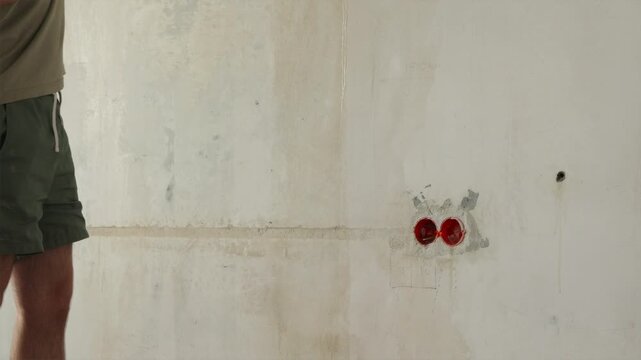 Low angle view of painter feet while rolling primer onto wall