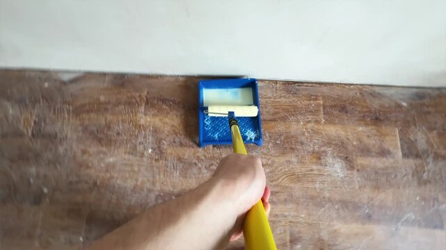 Wide angle perspective of priming ceiling with roller on extension pole