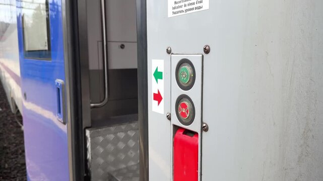 A passenger pushing a button on a train door to enter a carriage, representing convenient public transport access during a daily commute on a modern railway platform in the morning