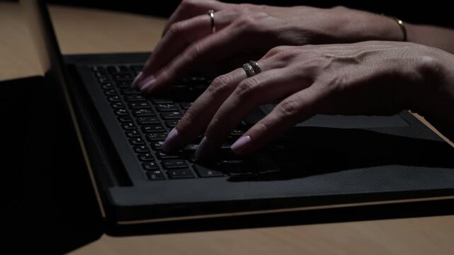 Detailed close-up of female hands typing on a laptop keyboard during office work, suitable for themes of technology, data entry, communication, productivity, and professional employment