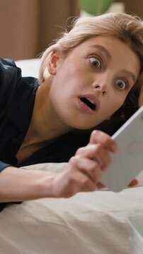 Caucasian woman waking up with alarm clock feeling panic with lateness female checking time in phone in bed quickly running late to work girl awake look in smartphone hurry rush in bedroom at morning