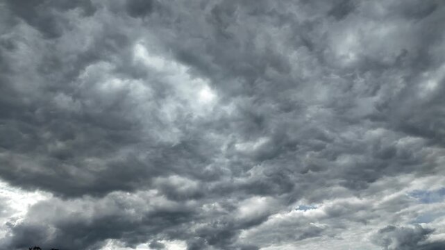 Black and gray clouds cover the sky. Clouds are approaching before a storm and rain with a thunderstorm