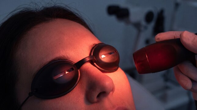 A female patient wearing protective black goggles undergoes a laser eye treatment procedure ad social media download thambnail poster web template event festival 2026 2027 2028