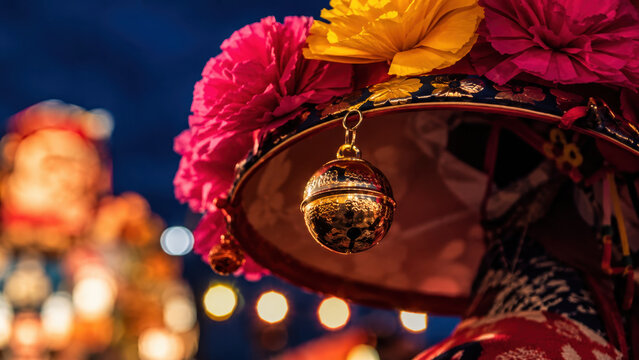 Colorful hanagasa hat with golden suzu bell during nebuta matsuri night procession, paper flowers, glowing lantern bokeh, traditional dancer costume, taiko rhythm, summer festival culture