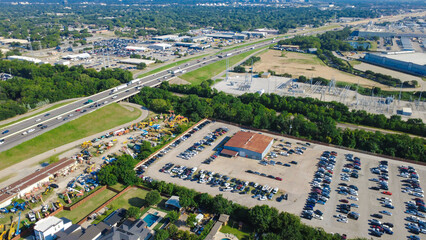 State Highway 183 elevated lanes span above verdant tree lines commercial machinery yards near S....