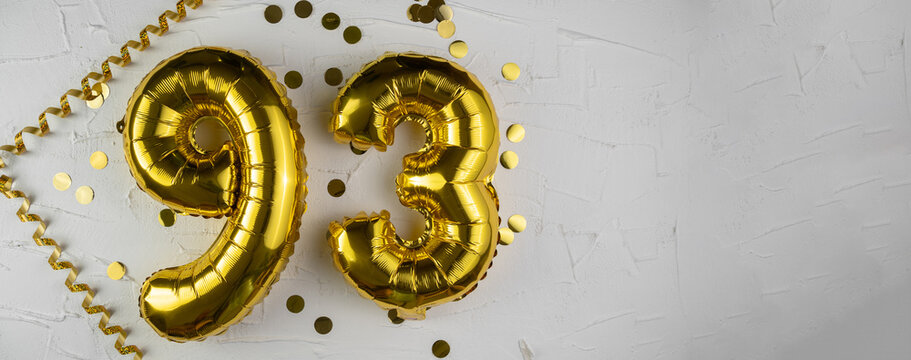 Yellow Gold foil balloon number ninety-three on white background. Birthday card with lettering 93. Anniversary concept. For anniversary, birthday, wedding event, new year celebration.