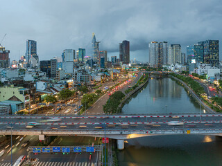Fototapeta premium Saigon Skyline and Traffic at Dusk Along a Canal